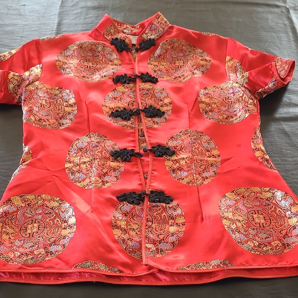 This is a red brocade Chinese Tang jacket with frog button closures. S/M.